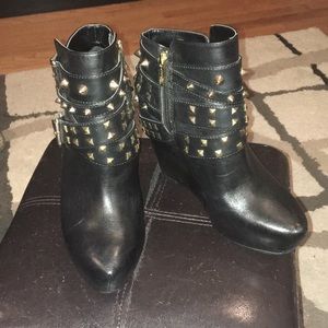 Very clean black leather booties with gold studs.